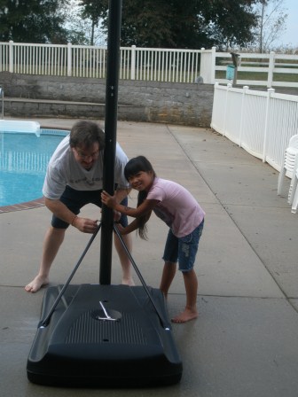 Daddy and Kasen putting up the basketball goal